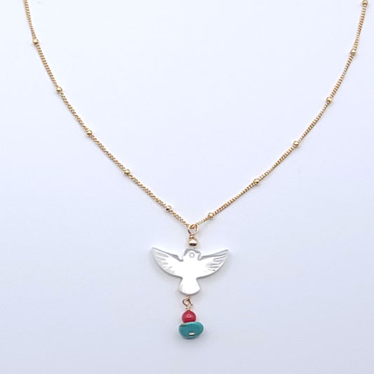 Wings of Hope Necklace featuring a mother-of-pearl bird pendant accented with turquoise and coral on an 16-inch gold-filled satellite chain.