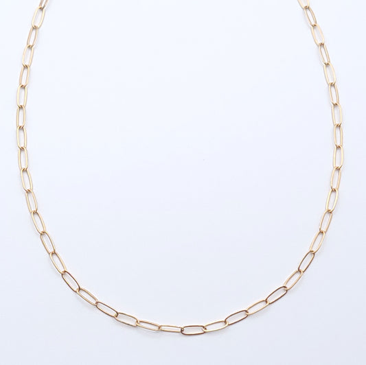Minimal gold-filled essential chain necklace on a soft light gray background