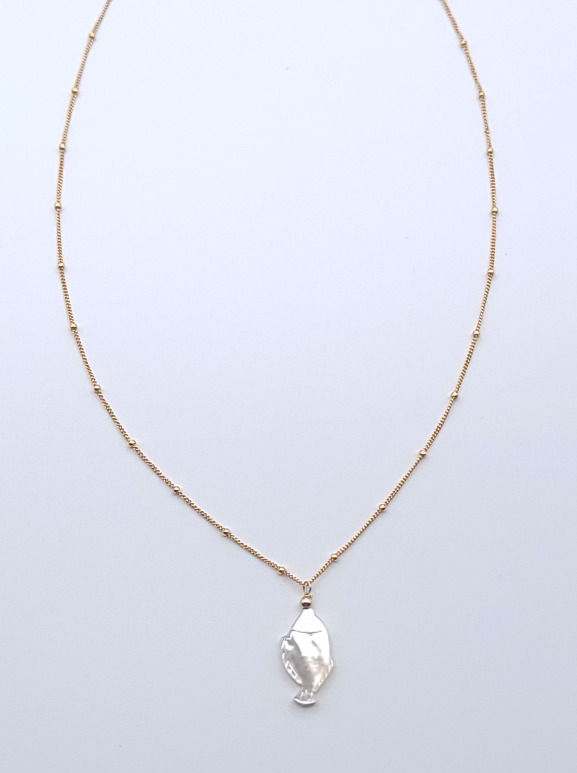 Lucky Fish Necklace featuring a natural mother-of-pearl fish pendant on an 18-inch gold-filled satellite chain.