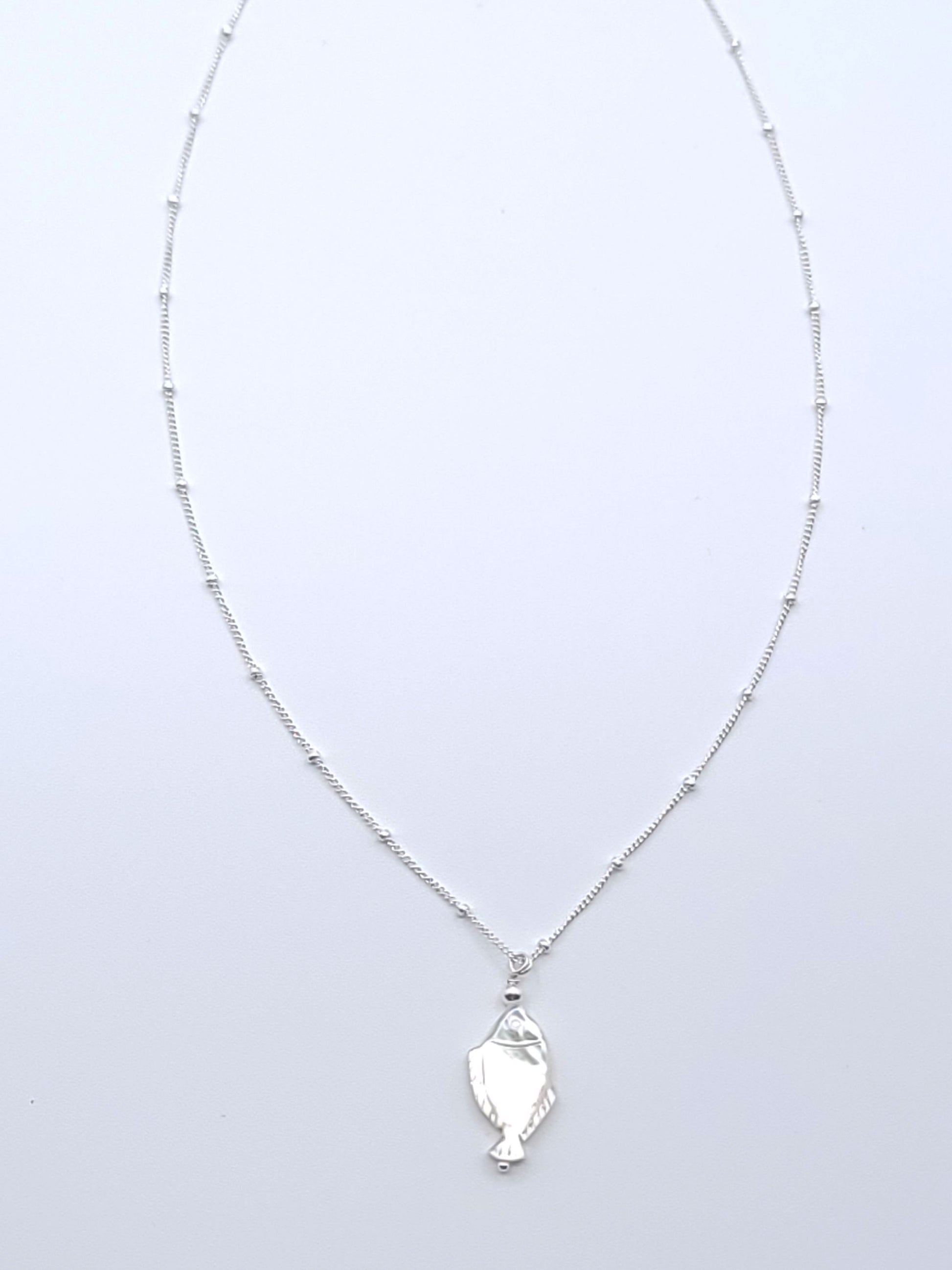 Lucky Fish Necklace featuring a natural mother-of-pearl fish pendant on an 18-inch sterling silver satellite chain.