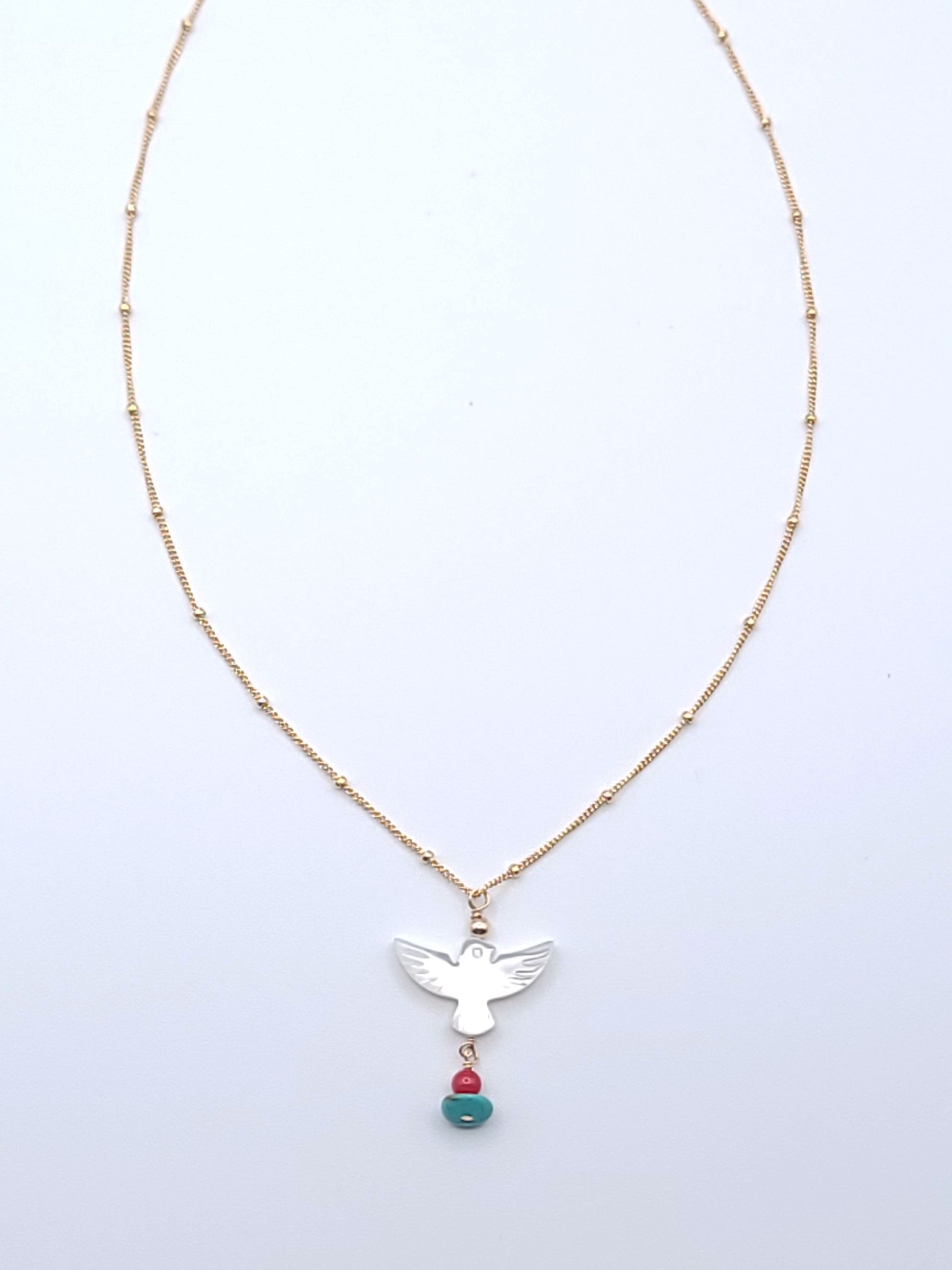 Wings of Hope Necklace featuring a mother-of-pearl bird pendant accented with turquoise and coral on an 16-inch gold-filled satellite chain.